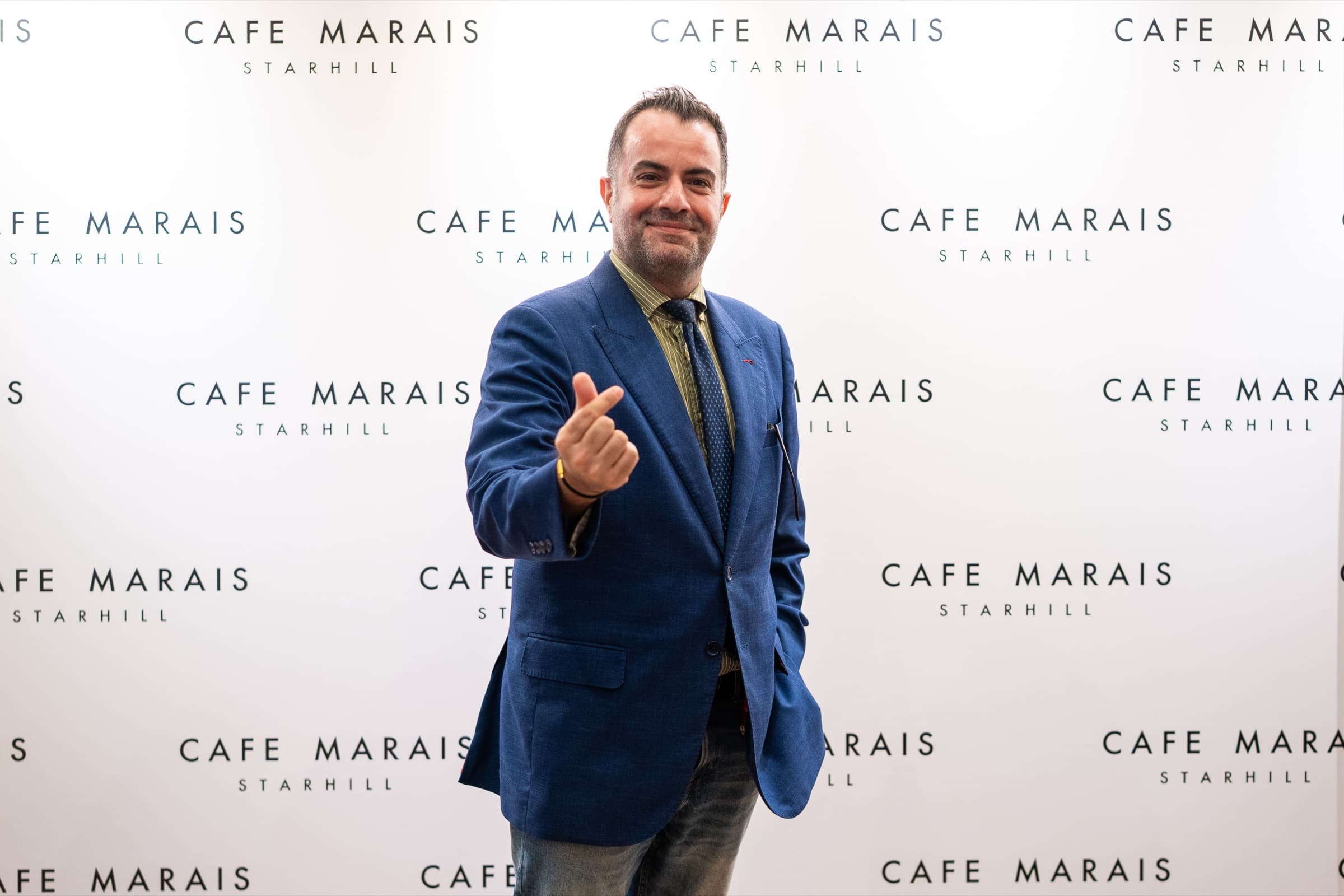 Founder portrait, Café Marais step-and-repeat