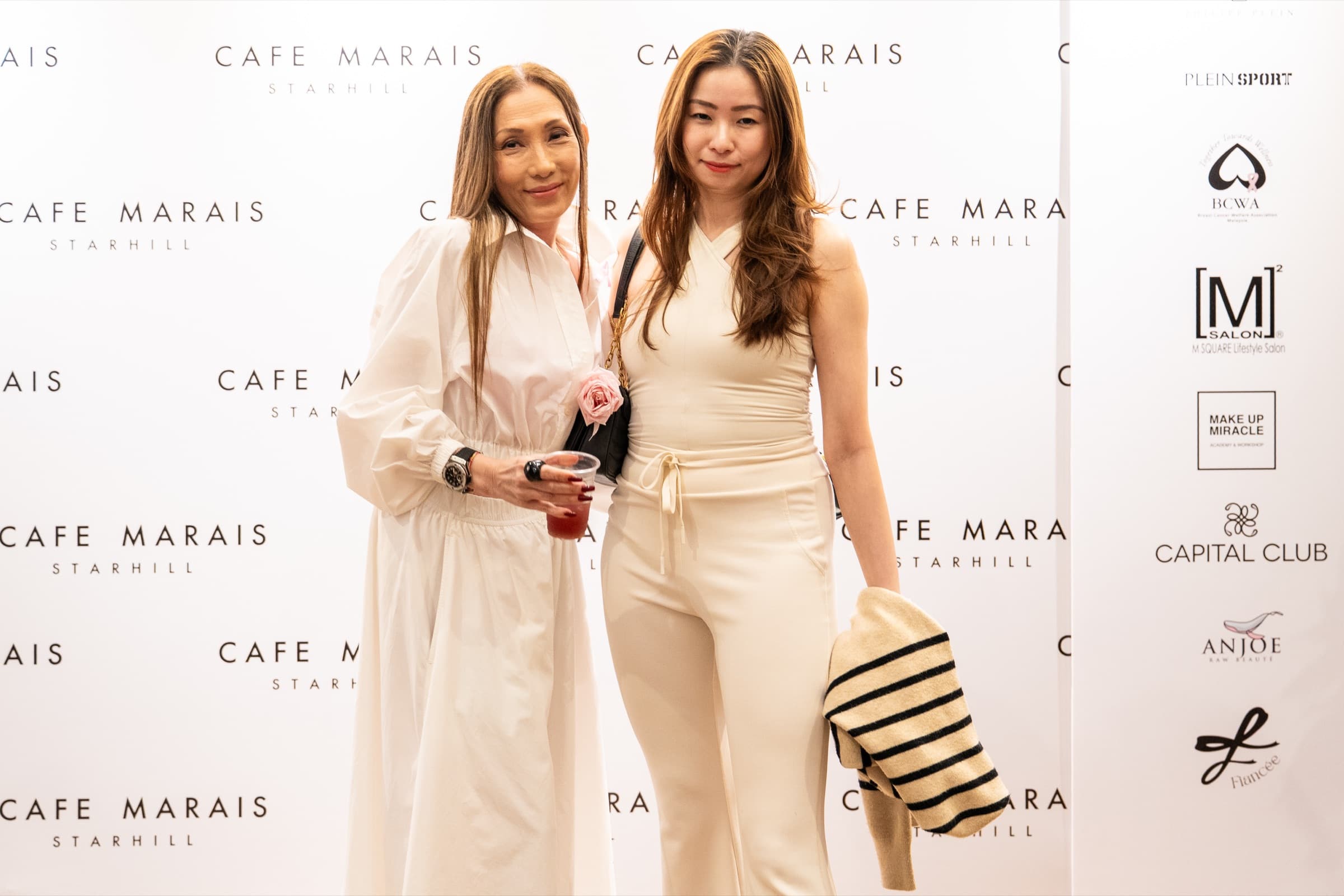 Guests with custom drinks at the launch backdrop